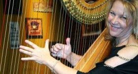Lori Andrews and her harp on the set of House Blend