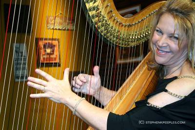 Lori Andrews and her harp on the set of House Blend