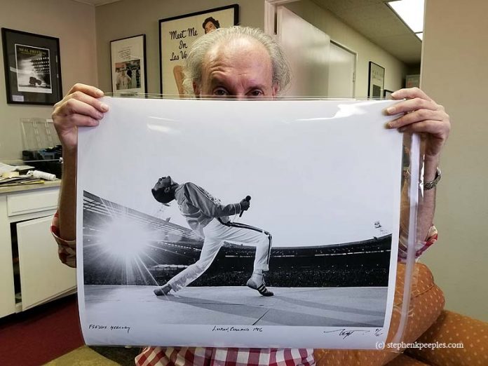 Neal Preston with photo he took of Freddie Mercury in London in 1986. Photo: Stephen K. Peeples.